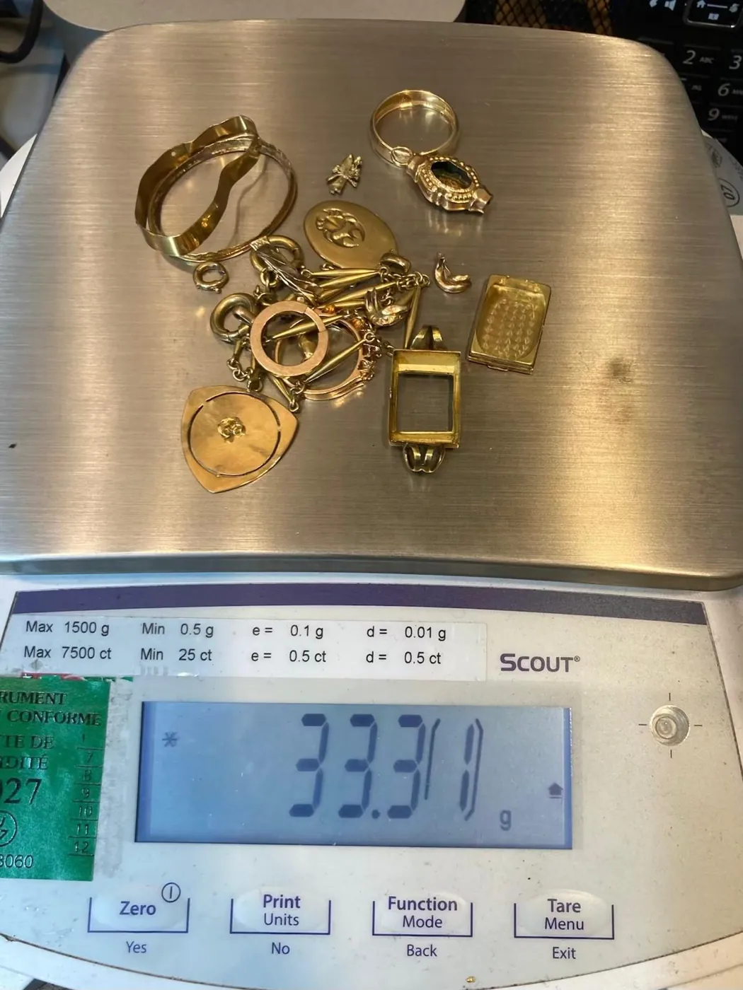 Lot de bijoux en or pesé sur une balance